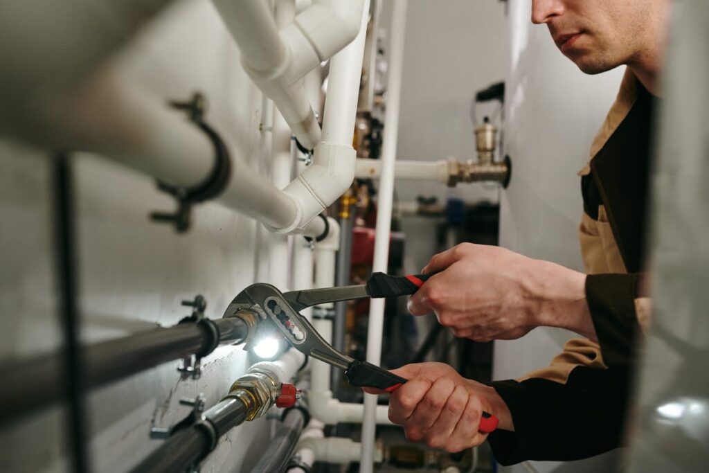 Plumbers maintaining commercial plumbing pipes in Alpharetta