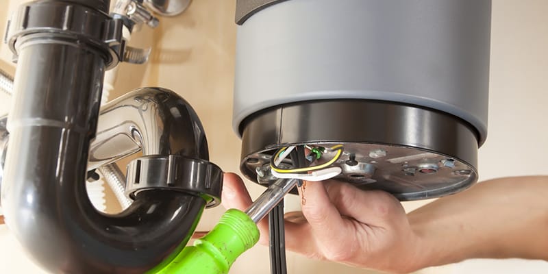 Technician repairing the heating element of a water heater in Alpharetta