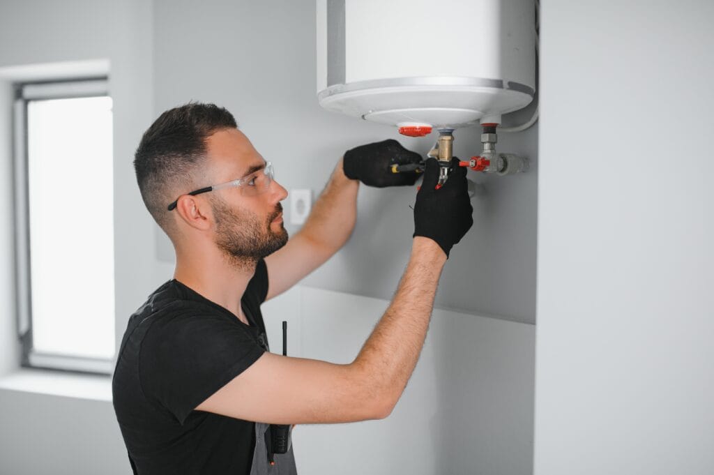 Technician performing water heater maintenance in Alpharetta